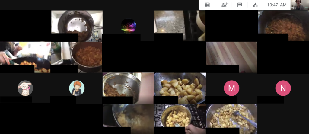 A screenshot showing a Google meeting of a classroom. About half of the students have their cameras on and are showing their progress cooking homemade applesauce.